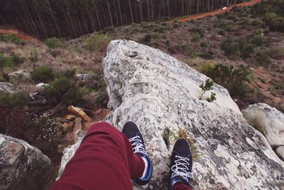 Low section of person standing on rock