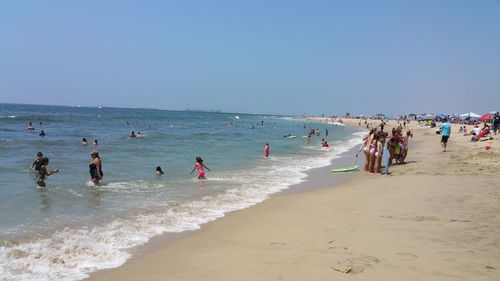 Scenic view of beach against blue sky