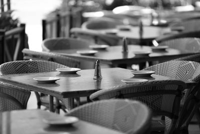 Close-up of empty chairs and table in cafe