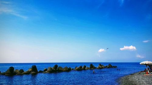 Scenic view of sea against blue sky