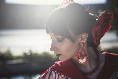 Close-up of young woman in traditional clothes outdoors