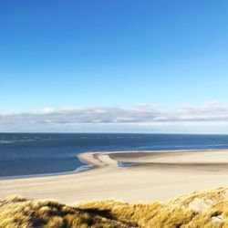 View of beach against blue sky