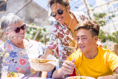 Portrait of a smiling young woman eating food