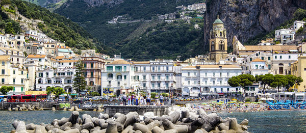 Panoramic view of small haven of amalfi village with turquoise sea and colorful houses on slopes 