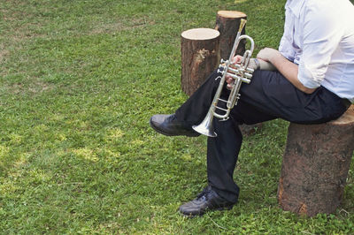 Low section of man playing guitar