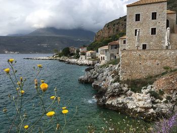 Scenic view of sea and buildings in town