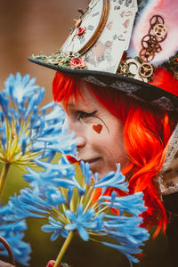 Portrait of woman with red flowers