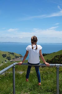 Rear view of girl with braids enjoying the view on the coromandel peninsula