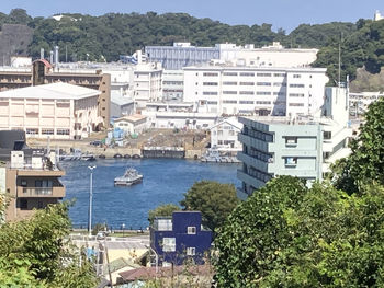 High angle view of buildings by sea in city