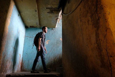 Full length of man standing in abandoned building