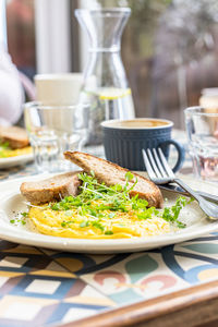 Omelette served with microgreen and toasted bread. healthy and tasty keto breakfast with coffee.