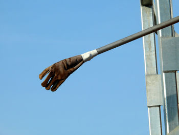 Low angle view of metal pole against clear blue sky