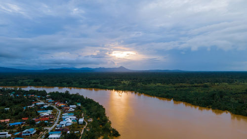 Scenic view of river against sky during sunset