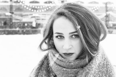 Portrait of smiling young woman with snow