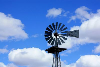 Low angle view of windmill against sky