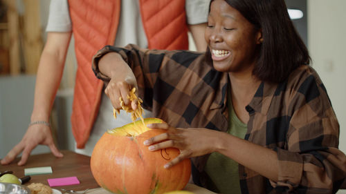 Portrait of woman holding pumpkin