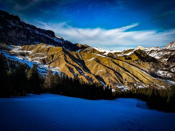 Scenic view of snowcapped mountains against sky during winter