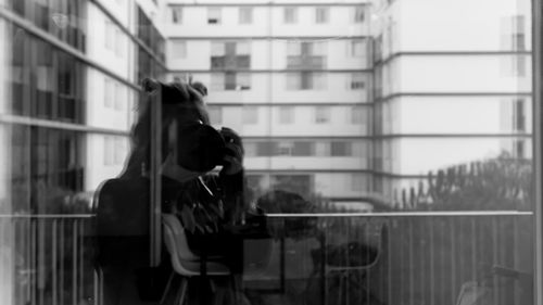 Woman holding mobile phone in city