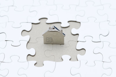 High angle view of key ring on jigsaw puzzle