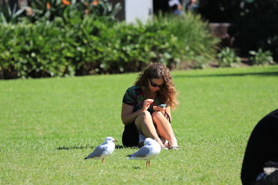 Young woman sitting on grass