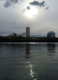 River in city against cloudy sky