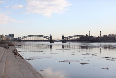 Bridge over river with city in background