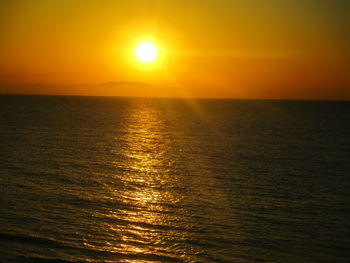 Scenic view of sea against orange sky