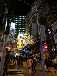 People walking on city street at night