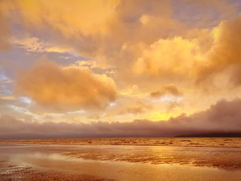 Scenic view of beach against sky during sunset