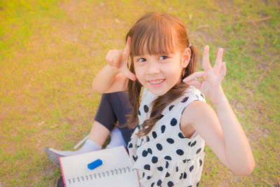 Portrait of happy girl holding grass