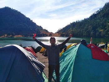 Panoramic shot of man standing on mountain against sky