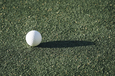 Close-up of golf ball on course