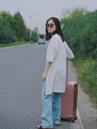 Young woman standing on road