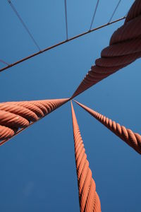 Low angle view of cables against clear blue sky