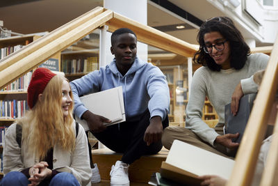 Students learning together in library