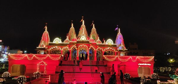 Low angle view of illuminated building against sky at night