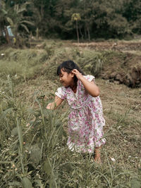 Full length of woman standing on field