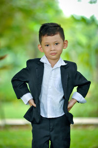 Portrait of boy standing on field