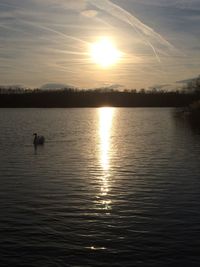 Scenic view of lake at sunset