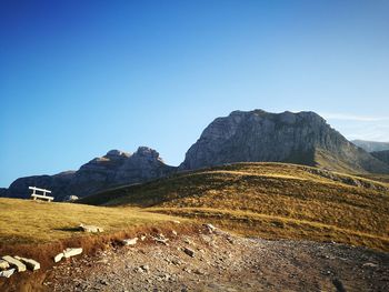 Scenic view of mountains against clear blue sky