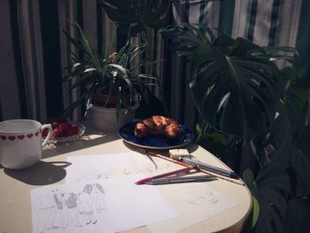 High angle view of drawing with food on table