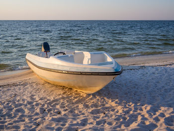 Boat on beach against clear sky