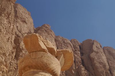 Low angle view of rock formation against clear sky
