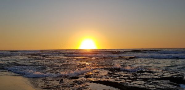 Scenic view of sea against sky during sunset