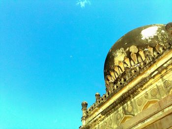 Low angle view of statue against blue sky