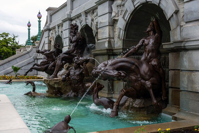 Statue by fountain