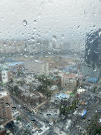 Full frame shot of wet glass window in rainy season