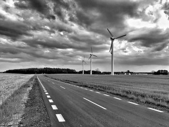 Country road passing through field