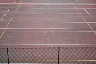 High angle view of chainlink fence on track and field