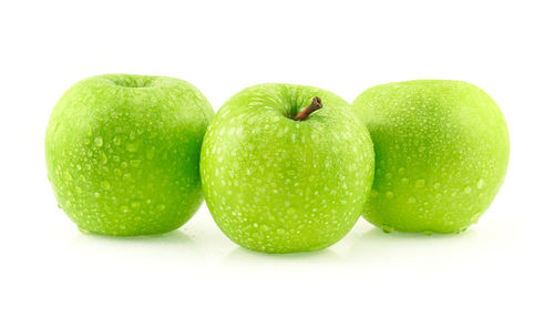 Close-up of granny smith apples against white background